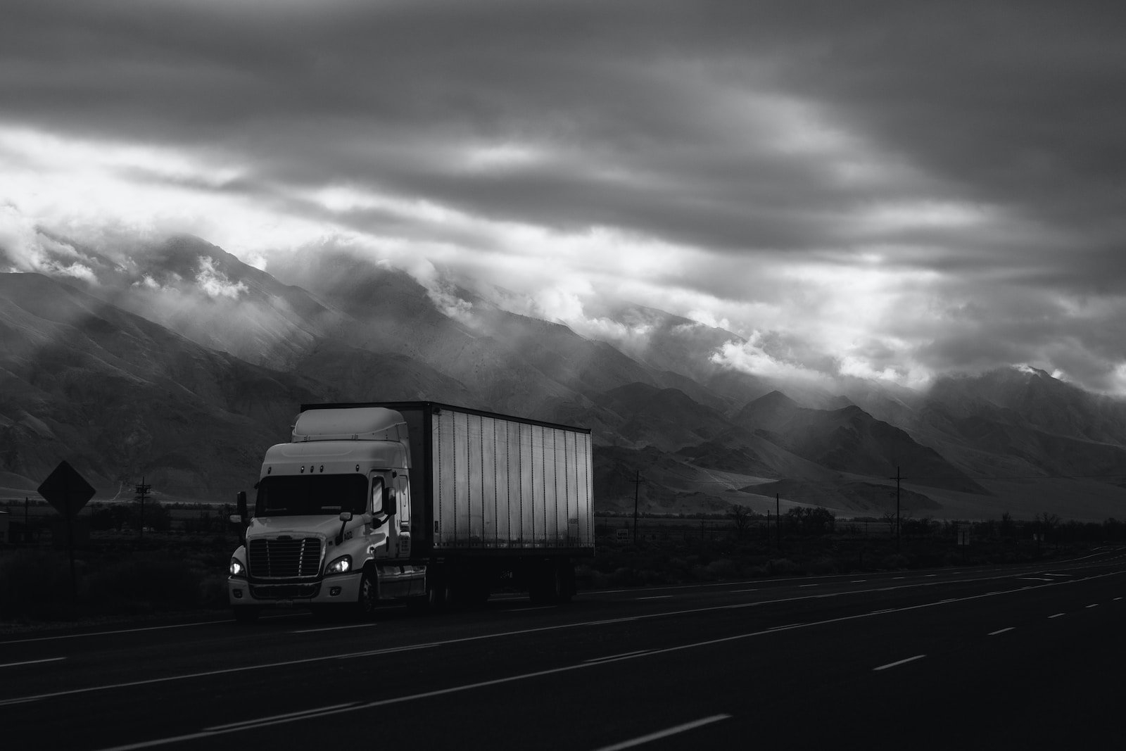 white trailer truck on road with cargo